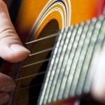 Close up on  hands playing on guitar
